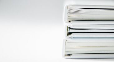 A stack of white books on a white background